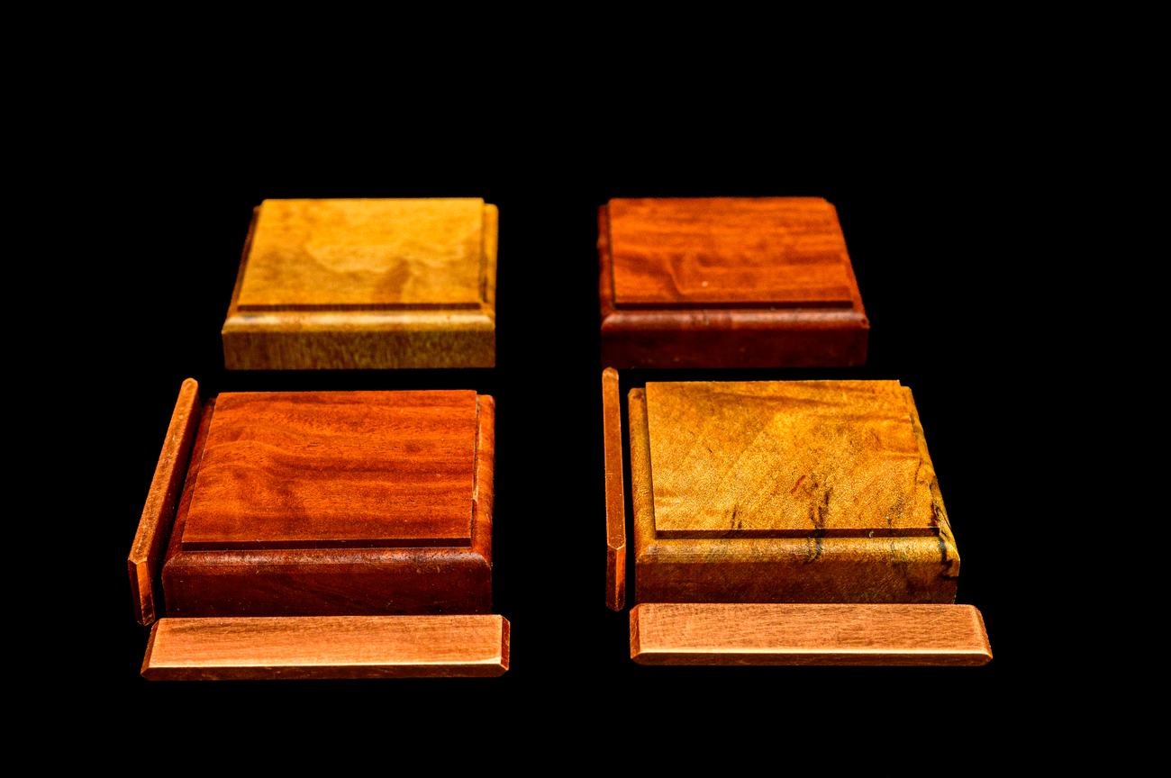 Four tiles joined into a two-by-two block, copper visible along every seam